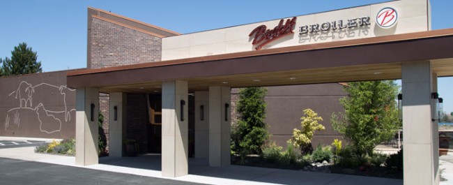 A view of the Budd's Broiler restaurant with artwork lining the side of the building.