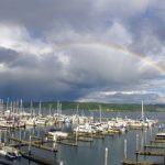 A rainbow graces the sky over the docks at Anthony's at Sinclair Inlet.
