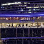 Anthony's Bell Street Diner at night with blue lights lining the exterior of the building and glowing against the waterfront.