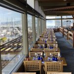 A view from inside the Anthony's HomePort Edmonds location overlooking docked boats along the water