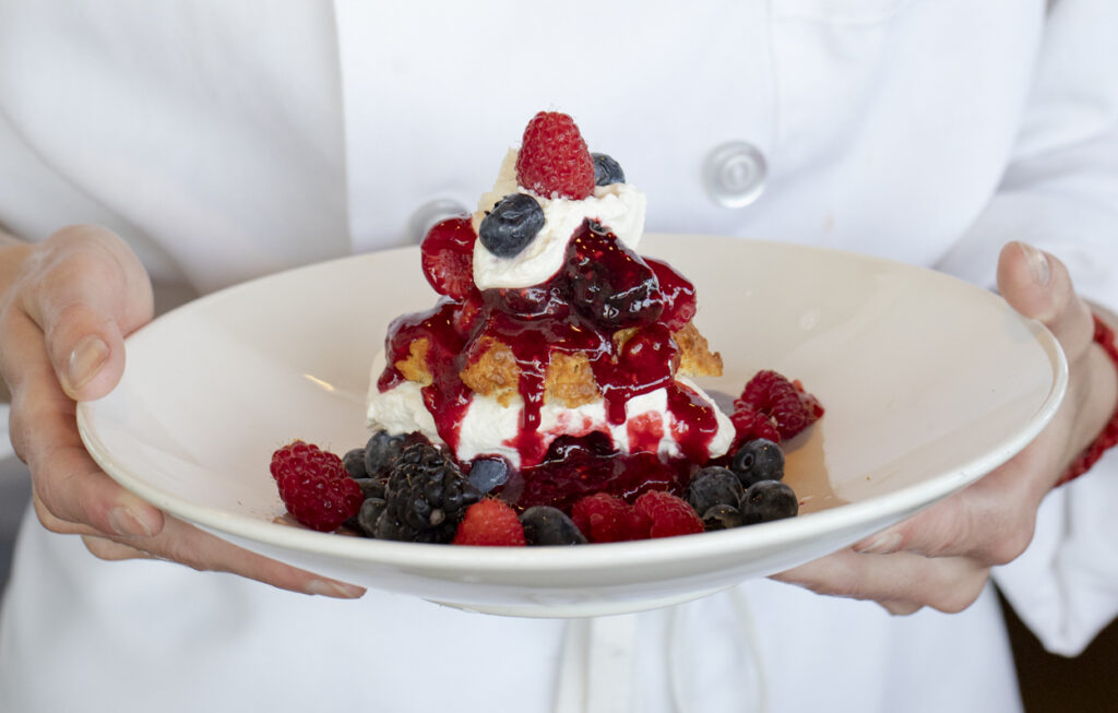 A vibrant mix of seasonal berries paired with homemade shortcake and whipped cream
